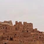 Cyclist riding through Taroudant Province, exploring Morocco's living heritage among ancient kasbahs, Amazigh villages, and scenic gravel roads 